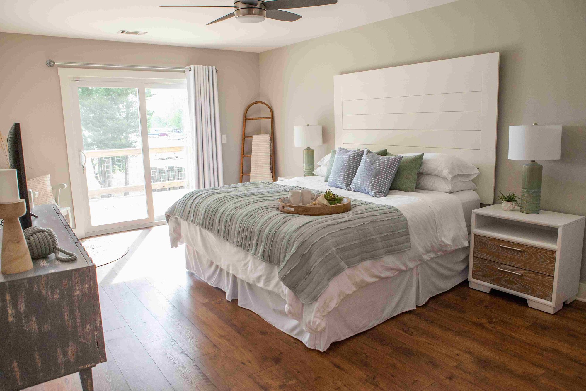 Primary Bedroom with Sliding Glass Door and Shiplap Headboard _ PAXISgroup Custom Home Builders in GA_11zon