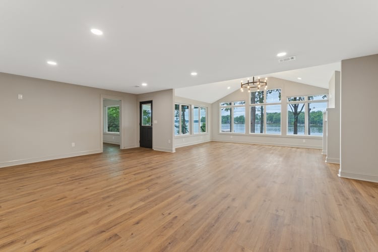 Large open concept style living space with natural light in custom home remodel by PAXISgroup