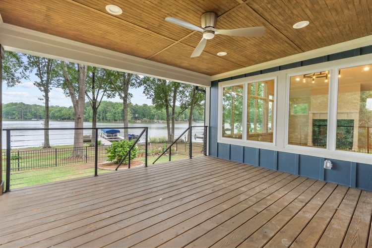 Outdoor deck with lake views in custom home remodel by PAXISgroup